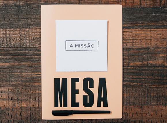A Mesa notebook with a card that reads A missão